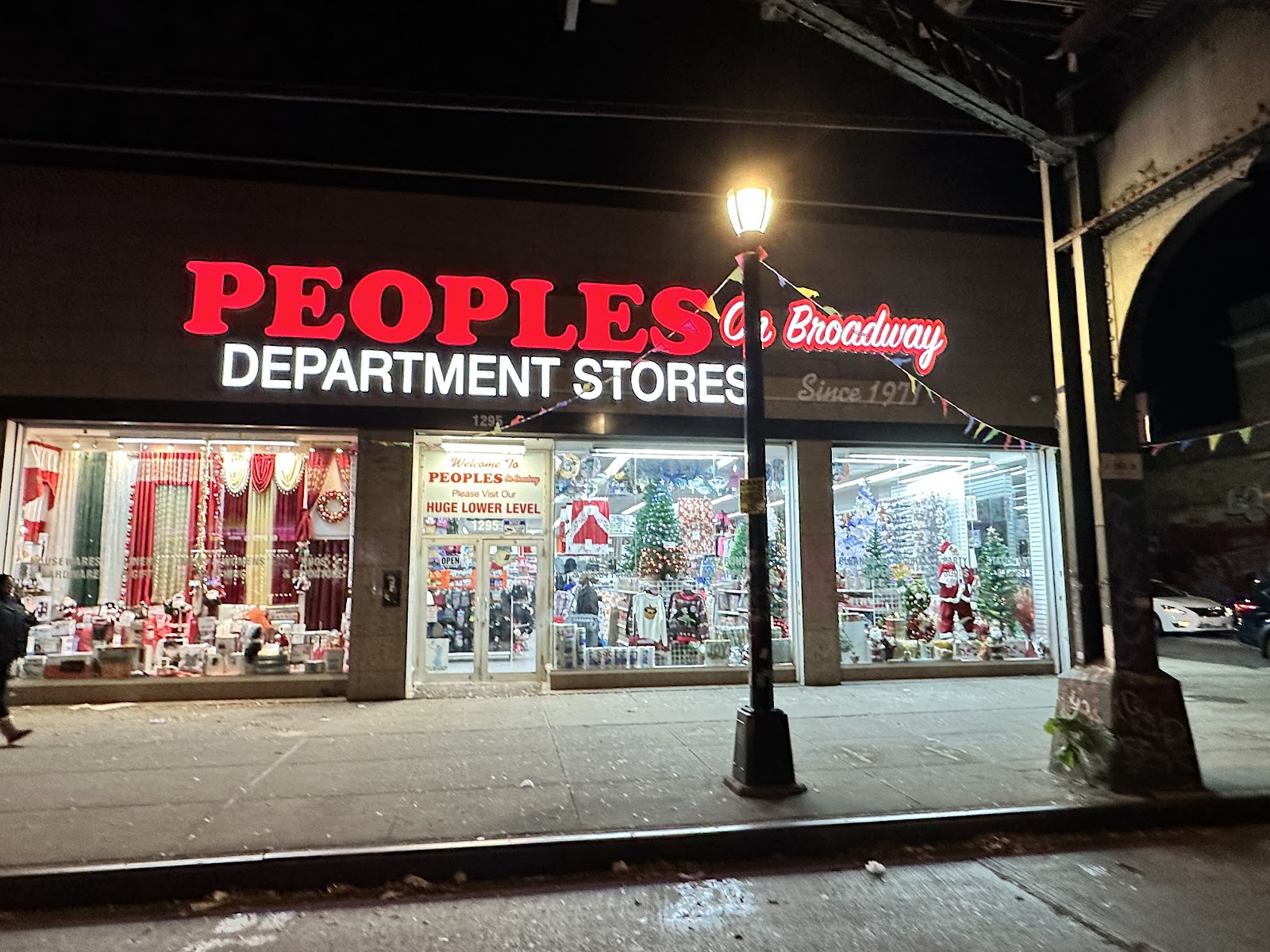 Peoples Department Store storefront on Broadway, Brooklyn at night