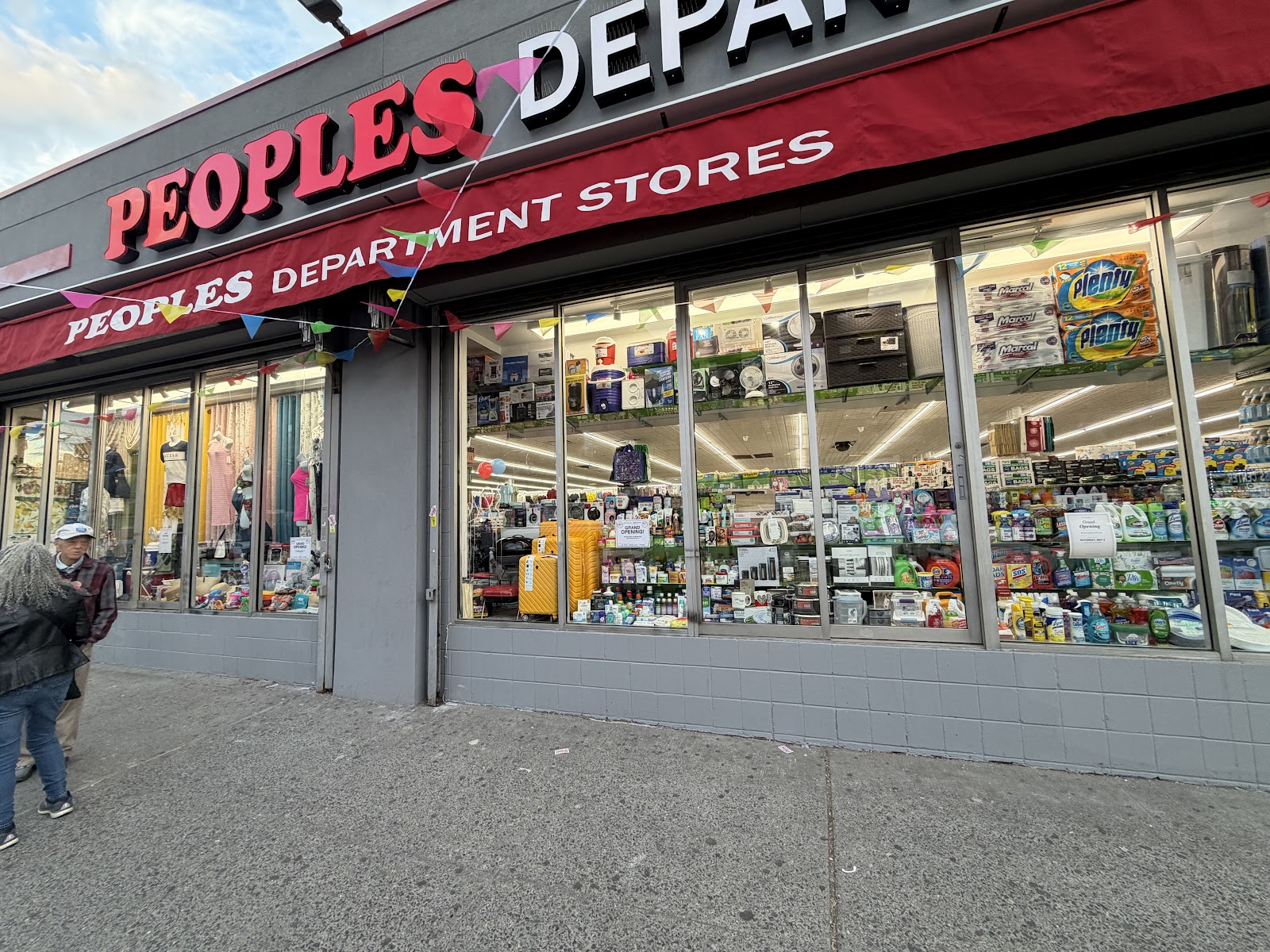 Front window display with luggage, cleaning supplies and household goods at Peoples Department Store in Inwood
