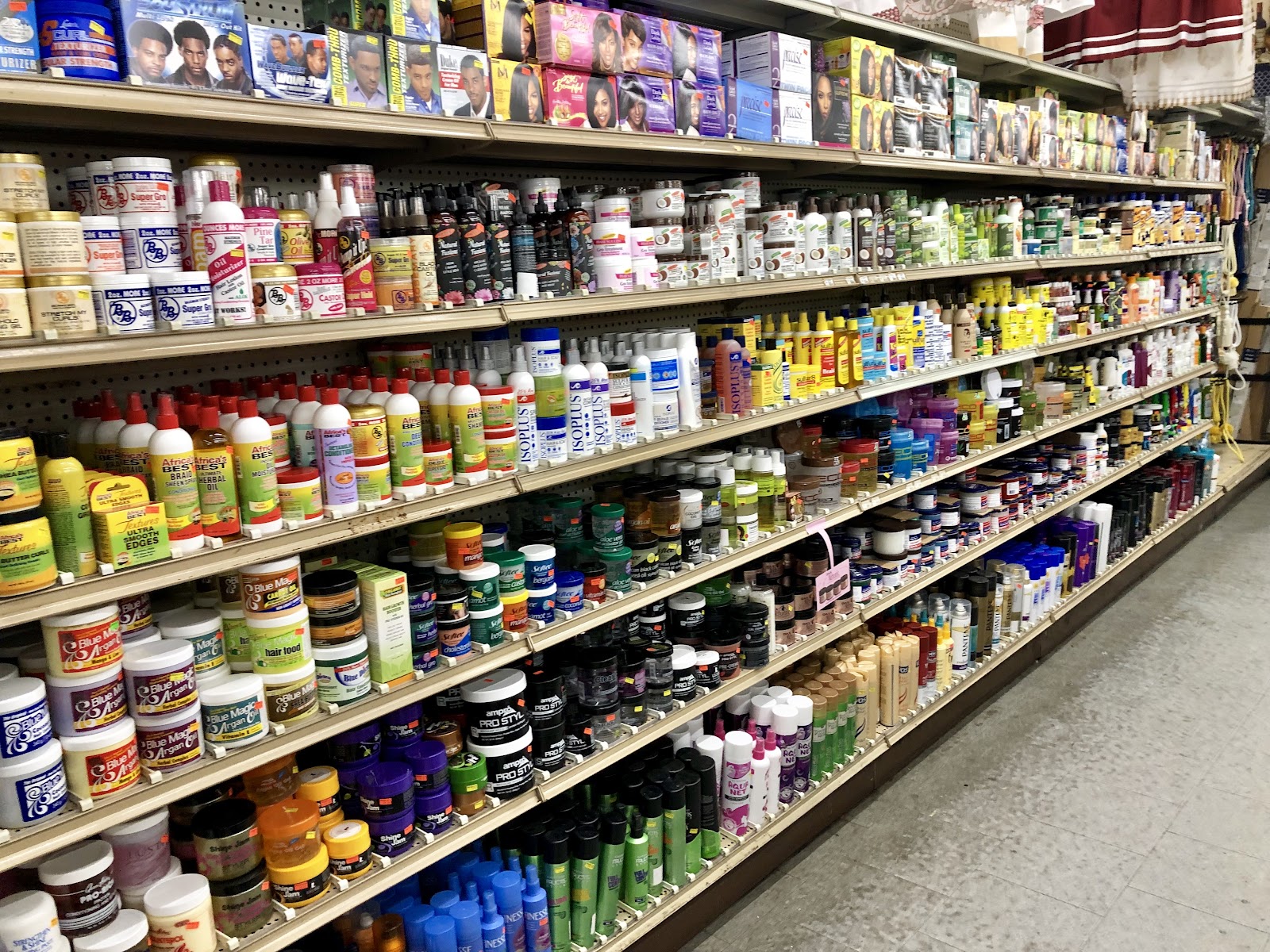 Hair care and beauty supply aisle at Peoples Department Store