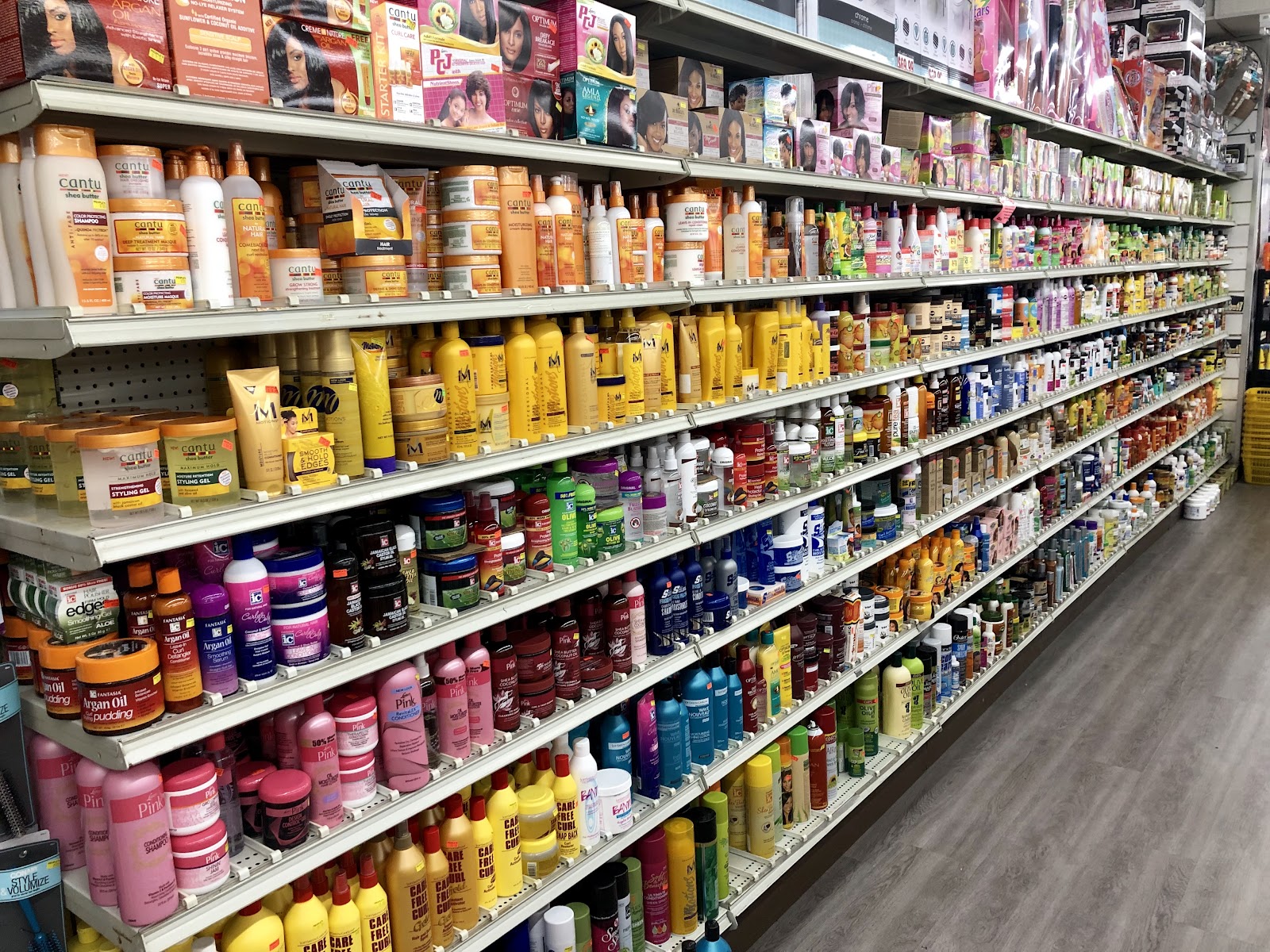 Shelves of hair care and beauty products in an aisle at Peoples Department Store