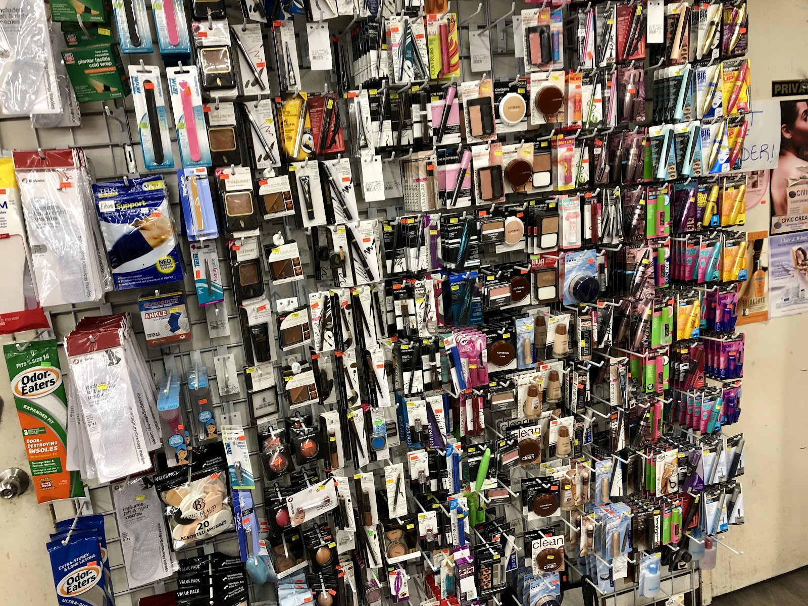 Wall of hanging hair pieces and hair accessories in the beauty supply department at Peoples Department Store