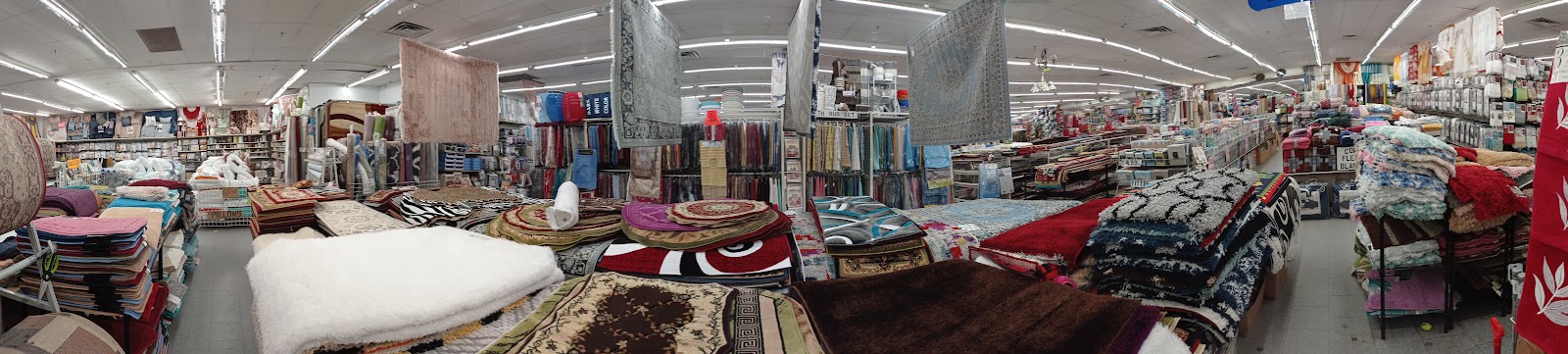 Rugs, comforters and bedding across the floor of Peoples Department Store on Ralph Avenue