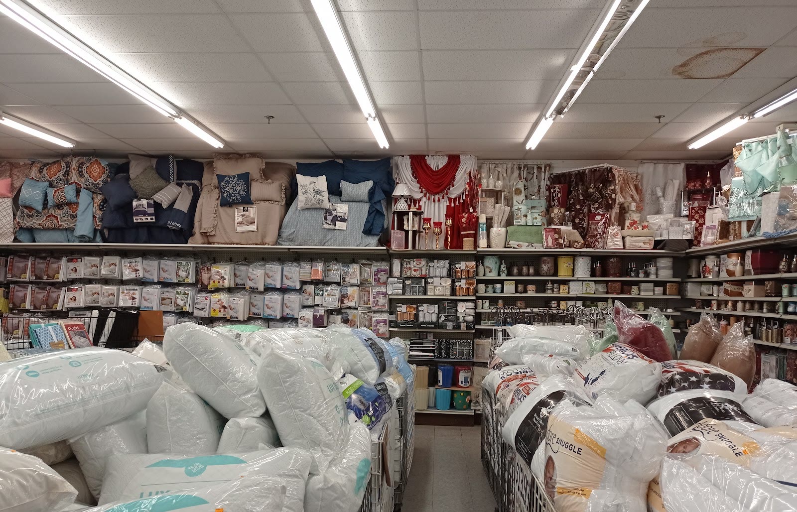 Comforters, pillows and bedding displays in the home goods and furniture department at Peoples Department Store