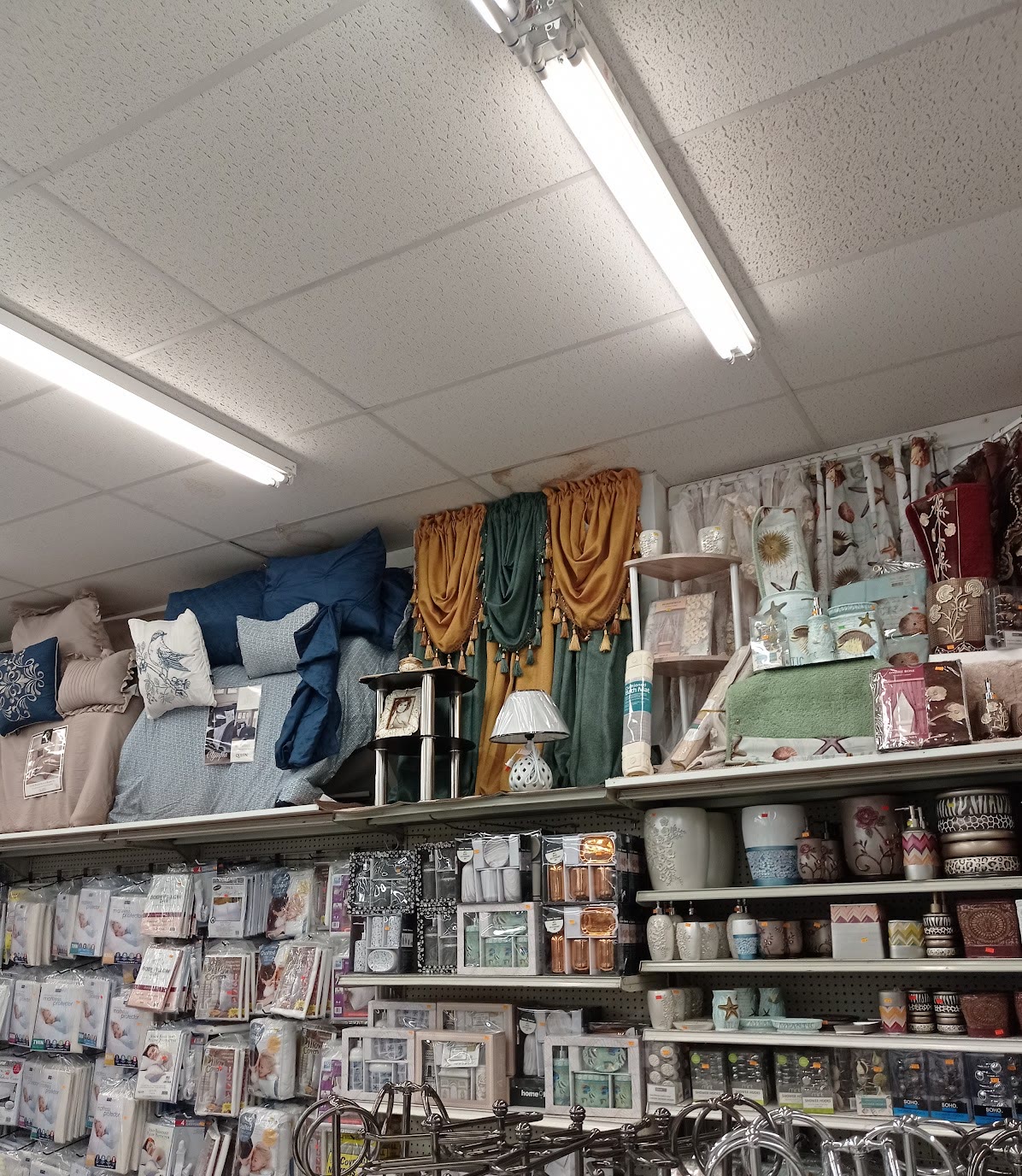 Bath linens and bathroom accessories on shelves at Peoples Department Store