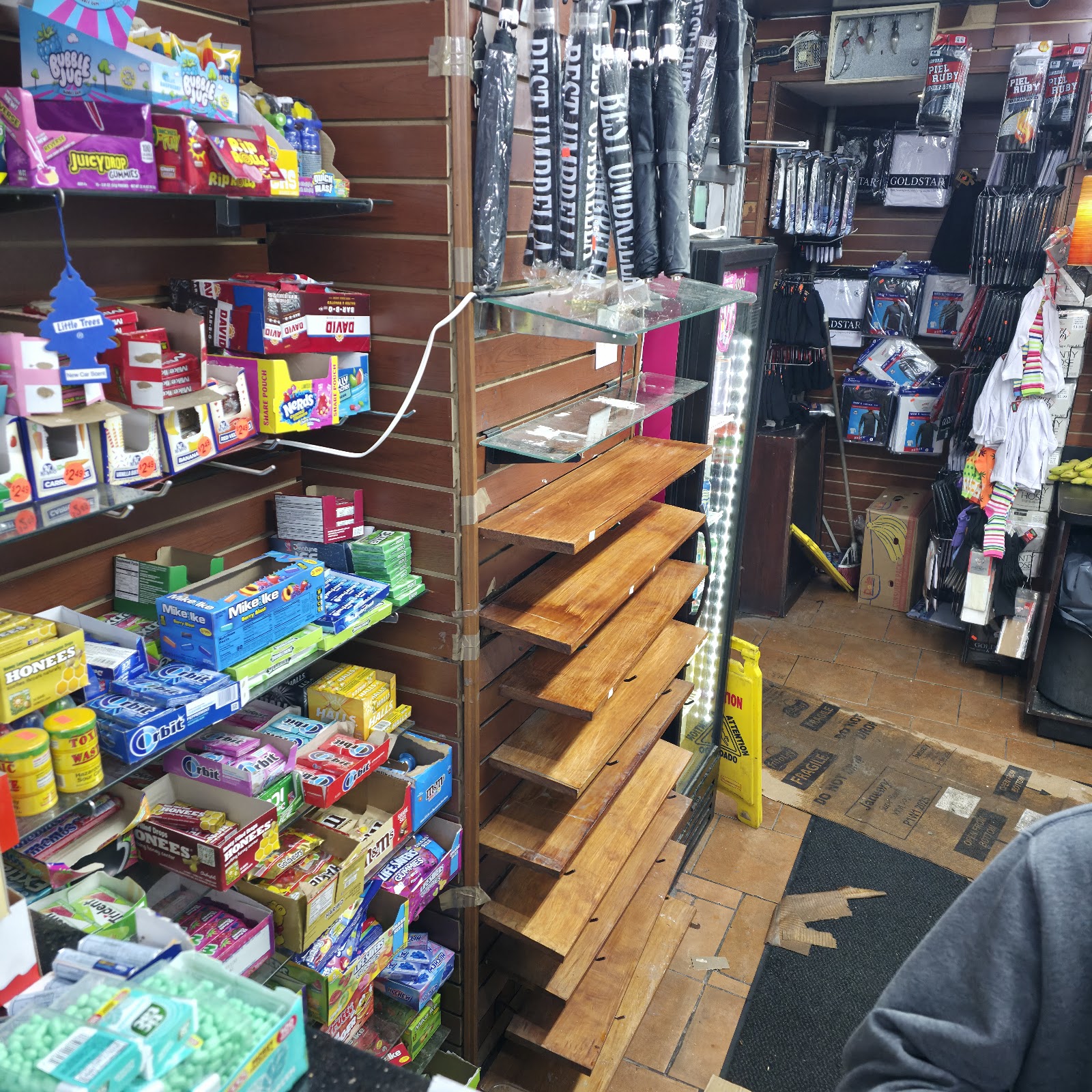 Candy, umbrellas and everyday accessories near the register at Peoples Department Store on Westchester Avenue